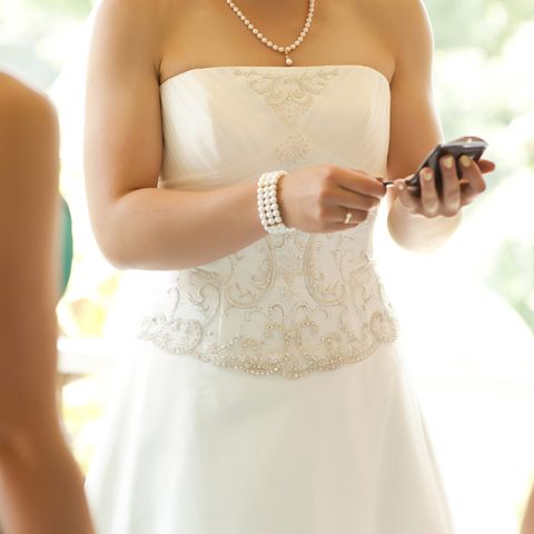 bride checking mobile phone royalty free image